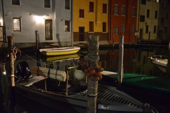 many boats moored on the canal at night in Chioggia in Veneto, Italy