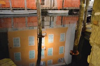 the reflections on the canal at night in Chioggia, Italy