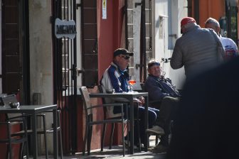 people gathered in the street where Ai Pescatori, a restaurant on Pellestrina, an island in Italy is