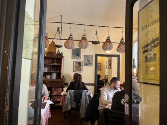hanging hams in Trattoria Corrieri, a restaurant in Parma, Italy