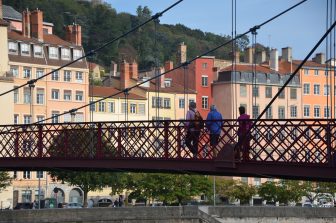 people crossing Passerelle St. Georges in Lyon, France