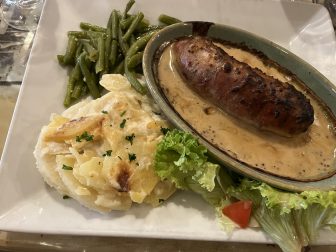 tripe sausage with mustard sauce at Le Petit Glouton, a bouchon in Lyon, France