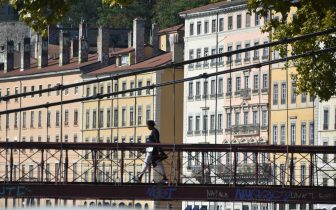 a person crossing a bridge in Lyon, France