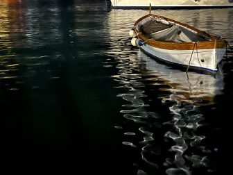 a boat and the reflections on the sea at the mort of Santa Margherita Ligure in northern Italy