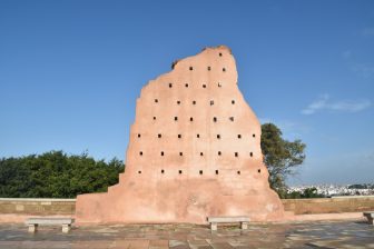 the pink wall against the blue sky at the site of Hassan Tower in Rabat, Morocco