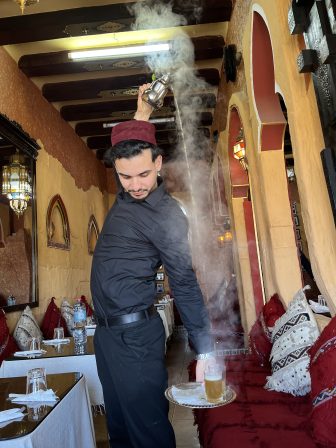 the waiter pouring the mint tea in Dar Naji Rabat, a restaurant in Rabat, Morocco