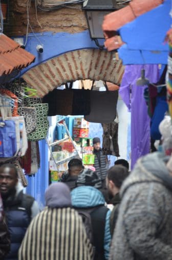 the street full of locals in Chefchaouen in Morocco