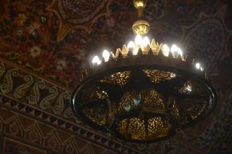 the ceiling and the chandelier in a room of the Bahia Palace in Marrakesh in Morocco.