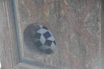 a hole on the door for cats in the Bahia Palace in Marrakesh, Morocco