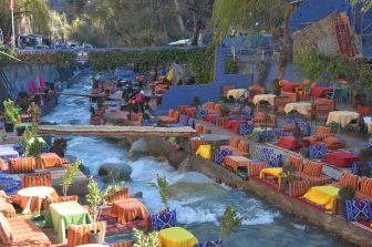 the Ourika River and colourful tables in Setti Fatma in Ourika Valley in Morocco