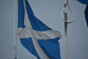 the Scottish flag at the border between Scotland and England