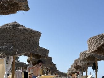 a row of strange looking parasols at Baia dei Turchi, a beach in the southern Italy